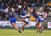 6 April 2024; Fidelma Marrinan of Clare kicks despite the attention of Caoimhe Cregg, left, and Saoirse Wynne of Roscommon during the Lidl LGFA National League Division 3 final match between Clare and Roscommon at St Brendan’s Park in Birr, Offaly. Photo by Ben McShane/Sportsfile