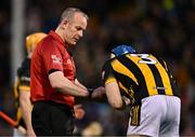 6 April 2024; Huw Lawlor of Kilkenny adjusts his helmet as referee Johnny Murphy prepares to speak to him during the Allianz Hurling League Division 1 final match between Clare and Kilkenny at FBD Semple Stadium in Thurles, Tipperary. Photo by Piaras Ó Mídheach/Sportsfile