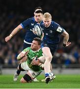 6 April 2024; Jamie Osborne of Leinster evades the tackle of Jasper Wiese of Leicester Tigers to set-up his side's third try during the Investec Champions Cup Round of 16 match between Leinster and Leicester Tigers at the Aviva Stadium in Dublin. Photo by Ramsey Cardy/Sportsfile