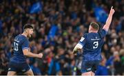 6 April 2024; Leinster players Ross Byrne, left, and Tadhg Furlong celebrates their side's fourth try, scored by teammate Robbie Henshaw, not pictured, during the Investec Champions Cup Round of 16 match between Leinster and Leicester Tigers at the Aviva Stadium in Dublin. Photo by Seb Daly/Sportsfile