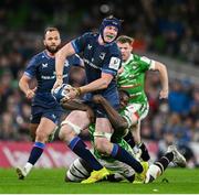 6 April 2024; Ryan Baird of Leinster is tackled by Emeka Ilione of Leicester Tigers during the Investec Champions Cup Round of 16 match between Leinster and Leicester Tigers at the Aviva Stadium in Dublin. Photo by Ramsey Cardy/Sportsfile