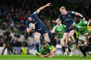 6 April 2024; Ryan Baird of Leinster evades the tackle of Francois van Wyk of Leicester Tigers during the Investec Champions Cup Round of 16 match between Leinster and Leicester Tigers at the Aviva Stadium in Dublin. Photo by Ramsey Cardy/Sportsfile