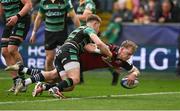 7 April 2024; Mike Haley of Munster scores his side's second try despite the tackle of Fin Smith of Northampton Saints during the Investec Champions Cup Round of 16 match between Northampton Saints and Munster at cinch Stadium at Franklin’s Gardens in Northampton, England. Photo by Brendan Moran/Sportsfile