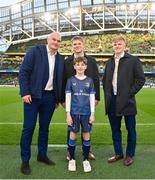 6 April 2024; Leinster players, from left, Rhys Ruddock, Rob Russell, and Tommy O'Brien with mascot Tadhg Duggan, age 10, from Blanchardstown, Dublin, before the Investec Champions Cup Round of 16 match between Leinster and Leicester Tigers at the Aviva Stadium in Dublin. Photo by Seb Daly/Sportsfile