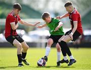 7 April 2024; Fionnán Galvin of Peamount United in action against Malahide United players Alex Jeal, left, and Alex Cioch during the FAI Under 17 Cup final match between Malahide United and Peamount United at Whitehall Stadium in Dublin. Photo by Seb Daly/Sportsfile