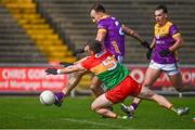 7 April 2024; Jonathan Bealin of Wexford shoots to score his side's second goal despite the efforts of Mikey Bambrick of Carlow during the Leinster GAA Football Senior Championship Round 1 match between Wexford and Carlow at Chadwicks Wexford Park in Wexford. Photo by Tyler Miller/Sportsfile