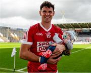 7 April 2024; Thomas Clancy of Cork celebrates victory with his son Leo, aged 3 months, after the Munster GAA Football Senior Championship quarter-final match between Cork and Limerick at SuperValu Páirc Ui Chaoimh in Cork. Photo by Tom Beary/Sportsfile