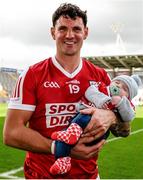 7 April 2024; Thomas Clancy of Cork celebrates victory with his son Leo, aged 3 months, after the Munster GAA Football Senior Championship quarter-final match between Cork and Limerick at SuperValu Páirc Ui Chaoimh in Cork. Photo by Tom Beary/Sportsfile