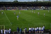 7 April 2024; The half-time Cavan minis team watch on as Paddy Lynch of Cavan kicks a free during the Ulster GAA Football Senior Championship preliminary round match between Monaghan and Cavan at St Tiernach's Park in Clones, Monaghan. Photo by Ramsey Cardy/Sportsfile