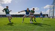 7 April 2024; Jordan Morris of Meath, left, rushes in as Patrick Fox of Longford vies for possession with James Conlon of Meath during the Leinster GAA Football Senior Championship Round 1 match between Longford and Meath at Glennon Brothers Pearse Park in Longford. Photo by Ray McManus/Sportsfile