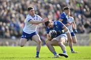 7 April 2024; Killian Brady of Cavan in action against David Garland of Monaghan during the Ulster GAA Football Senior Championship preliminary round match between Monaghan and Cavan at St Tiernach's Park in Clones, Monaghan. Photo by Daire Brennan/Sportsfile