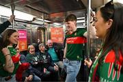 7 April 2024; Mayo supporters including Dylan Coleman from Knockmore, centre, Hannah Davidson, from Foxford, left, and Emma Coleman from Knockmore, right, ride the number one subway before the Connacht GAA Football Senior Championship quarter-final match between New York and Mayo at Gaelic Park in New York, USA. Photo by Sam Barnes/Sportsfile