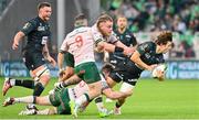 7 April 2024; Thomas Carol of Section Paloise is tackled by David Hankshaw of Connacht during the Challenge Cup Round of 16 match between Section Paloise and Connacht at Stade du Hameau in Pau, France. Photo by Loic Cousin/Sportsfile