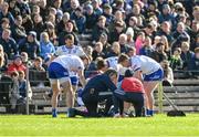 7 April 2024; Monaghan players gather around injured team-mate Darren Hughes during the Ulster GAA Football Senior Championship preliminary round match between Monaghan and Cavan at St Tiernach's Park in Clones, Monaghan. Photo by Daire Brennan/Sportsfile
