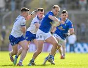 7 April 2024; Padraig Faulkner of Cavan in action against Conor McCarthy, left, and Joel Wilson of Monaghan during the Ulster GAA Football Senior Championship preliminary round match between Monaghan and Cavan at St Tiernach's Park in Clones, Monaghan. Photo by Daire Brennan/Sportsfile