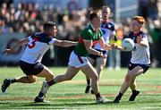 7 April 2024; Ryan O'Donoghue of Mayo in action against Jamie Boyle, left, and Tiernan Mathers of New Yorkduring the Connacht GAA Football Senior Championship quarter-final match between New York and Mayo at Gaelic Park in New York, USA. Photo by Sam Barnes/Sportsfile