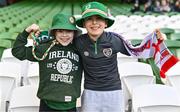 9 April 2024; Sister and brother Gabriela, age 10, and Adam Duggan, age 11, from Carlow, before the UEFA Women's European Championship qualifying group A match between Republic of Ireland and England at Aviva Stadium in Dublin. Photo by Ben McShane/Sportsfile