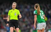 9 April 2024; Referee Lina Lehtovaara with Ruesha Littlejohn of Republic of Ireland before awarding a penalty to England after a handball by Littlejohn, during the UEFA Women's European Championship qualifying group A match between Republic of Ireland and England at Aviva Stadium in Dublin. Photo by Stephen McCarthy/Sportsfile