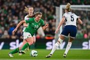 9 April 2024; Kyra Carusa of Republic of Ireland in action against Leah Williamson of England during the UEFA Women's European Championship qualifying group A match between Republic of Ireland and England at Aviva Stadium in Dublin. Photo by Ramsey Cardy/Sportsfile
