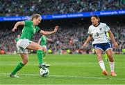 9 April 2024; Kyra Carusa of Republic of Ireland in action against Jess Carter of England during the UEFA Women's European Championship qualifying group A match between Republic of Ireland and England at Aviva Stadium in Dublin. Photo by Ramsey Cardy/Sportsfile Photo by Ramsey Cardy/Sportsfile