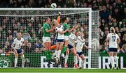 9 April 2024; England goalkeeper Hannah Hampton punches clear of Caitlin Hayes and Anna Patten of Republic of Ireland during the UEFA Women's European Championship qualifying group A match between Republic of Ireland and England at Aviva Stadium in Dublin. Photo by Ramsey Cardy/Sportsfile
