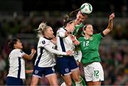 9 April 2024; Caitlin Hayes of Republic of Ireland wins a header ahead of teammate Anna Patten and England players, from left, Jessica Carter, Alex Greenwood and Lucy Bronze during the UEFA Women's European Championship qualifying group A match between Republic of Ireland and England at Aviva Stadium in Dublin. Photo by Ben McShane/Sportsfile