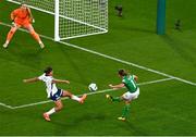 9 April 2024; Katie McCabe of Republic of Ireland has a shot on goal despite the efforts of Jessica Carter of England during the UEFA Women's European Championship qualifying group A match between Republic of Ireland and England at Aviva Stadium in Dublin. Photo by Tyler Miller/Sportsfile