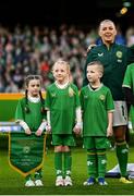 9 April 2024; Katie McCabe of Republic of Ireland and her mascots before the UEFA Women's European Championship qualifying group A match between Republic of Ireland and England at Aviva Stadium in Dublin. Photo by Stephen McCarthy/Sportsfile