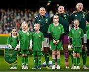 9 April 2024; Republic of Ireland players, from left, Katie McCabe, goalkeeper Courtney Brosnan and Louise Quinn with their mascots before the UEFA Women's European Championship qualifying group A match between Republic of Ireland and England at Aviva Stadium in Dublin. Photo by Stephen McCarthy/Sportsfile