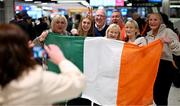 10 April 2024; Republic of Ireland's Ellen Dolan celebrates with family on the team's arrival at Dublin Airport from Croatia where the Republic of Ireland Women's U19 squad qualified for July's UEFA Women's U19 European Championships to be held in Lithuania. Photo by Stephen McCarthy/Sportsfile