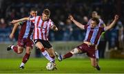 12 April 2024; Ronan Boyce of Derry City is tackled by Darragh Markey of Drogheda United  during the SSE Airtricity Men's Premier Division match between Drogheda United and Derry City at Weavers Park in Drogheda, Louth. Photo by Ramsey Cardy/Sportsfile