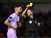 12 April 2024; Jordan Flores of Bohemians is shown a yellow card by referee Paul McLaughlin during the SSE Airtricity Men's Premier Division match between Shelbourne and Bohemians at Tolka Park in Dublin. Photo by Stephen McCarthy/Sportsfile
