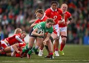 13 April 2024; Eve Higgins of Ireland scores her side's second try despite the tackle of Alisha Butchers of Wales during the Women's Six Nations Rugby Championship match between Ireland and Wales at Virgin Media Park in Cork. Photo by Brendan Moran/Sportsfile