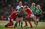 13 April 2024; Eve Higgins of Ireland is tackled by Carys Phillips and Georgia Evans of Wales during the Women's Six Nations Rugby Championship match between Ireland and Wales at Virgin Media Park in Cork. Photo by Brendan Moran/Sportsfile
