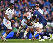 13 April 2024; Tolu Latu of La Rochelle is tackled by Caelan Doris of Leinster during the Investec Champions Cup quarter-final match between Leinster and La Rochelle at the Aviva Stadium in Dublin. Photo by Ramsey Cardy/Sportsfile