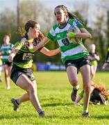 13 April 2024; Alice Boland of Naas on her way to scoring her side's first try despite the efforts of Anna Taylor of Portdara during the Leinster Rugby Girl's U18 semi-final match between Naas and Portdara at Naas RFC in Kildare. Photo by Tyler Miller/Sportsfile