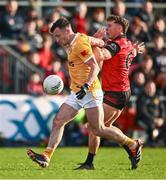 13 April 2024; Dermot McAleese of Antrim is tackled by Pierce Laverty of Down during the Ulster GAA Football Senior Championship quarter-final match between Down and Antrim at Páirc Esler in Newry, Down. Photo by Ben McShane/Sportsfile