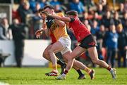 13 April 2024; Dermot McAleese of Antrim is tackled by Pierce Laverty, left, and Shealan Johnston of Down during the Ulster GAA Football Senior Championship quarter-final match between Down and Antrim at Páirc Esler in Newry, Down. Photo by Ben McShane/Sportsfile