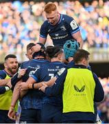 13 April 2024; Ryan Baird of Leinster, hidden, celebrates with teammates after scoring their side's third try during the Investec Champions Cup quarter-final match between Leinster and La Rochelle at the Aviva Stadium in Dublin. Photo by Ramsey Cardy/Sportsfile