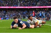 13 April 2024; Dan Sheehan of Leinster dives over to score his side's fourth try despite the tackle of Jonathan Danty of La Rochelle during the Investec Champions Cup quarter-final match between Leinster and La Rochelle at the Aviva Stadium in Dublin. Photo by Ramsey Cardy/Sportsfile