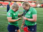 13 April 2024; Sadhbh McGrath, left, admires the player of the match medal awarded to teammate Aoife Wafer after the Women's Six Nations Rugby Championship match between Ireland and Wales at Virgin Media Park in Cork. Photo by Brendan Moran/Sportsfile