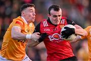 13 April 2024; Conor McCrickard of Down is tackled by Declan Lynch of Antrim during the Ulster GAA Football Senior Championship quarter-final match between Down and Antrim at Páirc Esler in Newry, Down. Photo by Ben McShane/Sportsfile