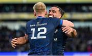 13 April 2024; James Lowe of Leinster celebrates with Jamie Osborne, 12, after scoring their side's fifth try during the Investec Champions Cup quarter-final match between Leinster and La Rochelle at the Aviva Stadium in Dublin. Photo by Ramsey Cardy/Sportsfile