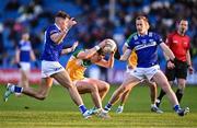 13 April 2024; Nathan Poland of Offaly in action against Kevin Swayne, left, and Paul Kingston of Laois during the Leinster GAA Football Senior Championship quarter-final match between Offaly and Laois at Laois Hire O’Moore Park in Portlaoise, Laois. Photo by Piaras Ó Mídheach/Sportsfile
