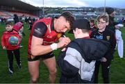 13 April 2024; Down captain Pierce Laverty signs autographs for supporters after the Ulster GAA Football Senior Championship quarter-final match between Down and Antrim at Páirc Esler in Newry, Down. Photo by Ben McShane/Sportsfile