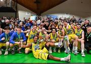 13 April 2024; UCD Marian players celebrate with supporters and the cup after the InsureMyVan.ie Division 1 play-off final match between UCD Marian and Moy Tolka Rovers at the National Basketball Arena in Tallaght, Dublin. Photo by Tyler Miller/Sportsfile