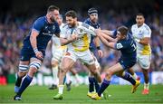 13 April 2024; Tawera Kerr-Barlow of La Rochelle is tackled by Jason Jenkins, left, and Jordan Larmour of Leinster during the Investec Champions Cup quarter-final match between Leinster and La Rochelle at the Aviva Stadium in Dublin. Photo by Ramsey Cardy/Sportsfile