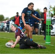 14 April 2024; Rachel Palmer of Roscrea scores a try despite the attempts of Rhiannon Hoey of Navan during the Women's Division 5 Cup final match between Navan and Roscrea during the Bank of Ireland Leinster Rugby Women Finals Day at Balbriggan RFC in Dublin. Photo by Ben McShane/Sportsfile