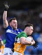 13 April 2024; Nathan Poland of Offaly in action against Eoin Lowry of Laois during the Leinster GAA Football Senior Championship quarter-final match between Offaly and Laois at Laois Hire O’Moore Park in Portlaoise, Laois. Photo by Piaras Ó Mídheach/Sportsfile