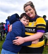 14 April 2024; Newbridge captain Charlotte Connolly celebrates with her son Ben after her side's victory in the Women's Division 5 Plate final match between Newbridge and Garda during the Bank of Ireland Leinster Rugby Women Finals Day at Balbriggan RFC in Dublin. Photo by Ben McShane/Sportsfile